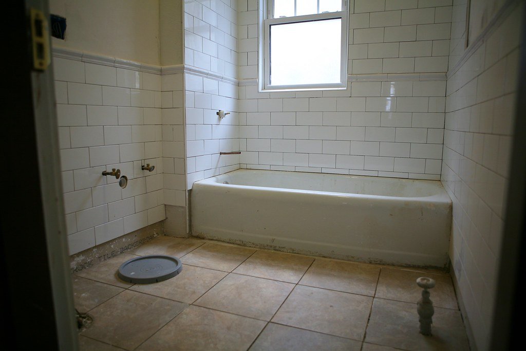 Bathroom remodel in progress with new subway tile around the tub