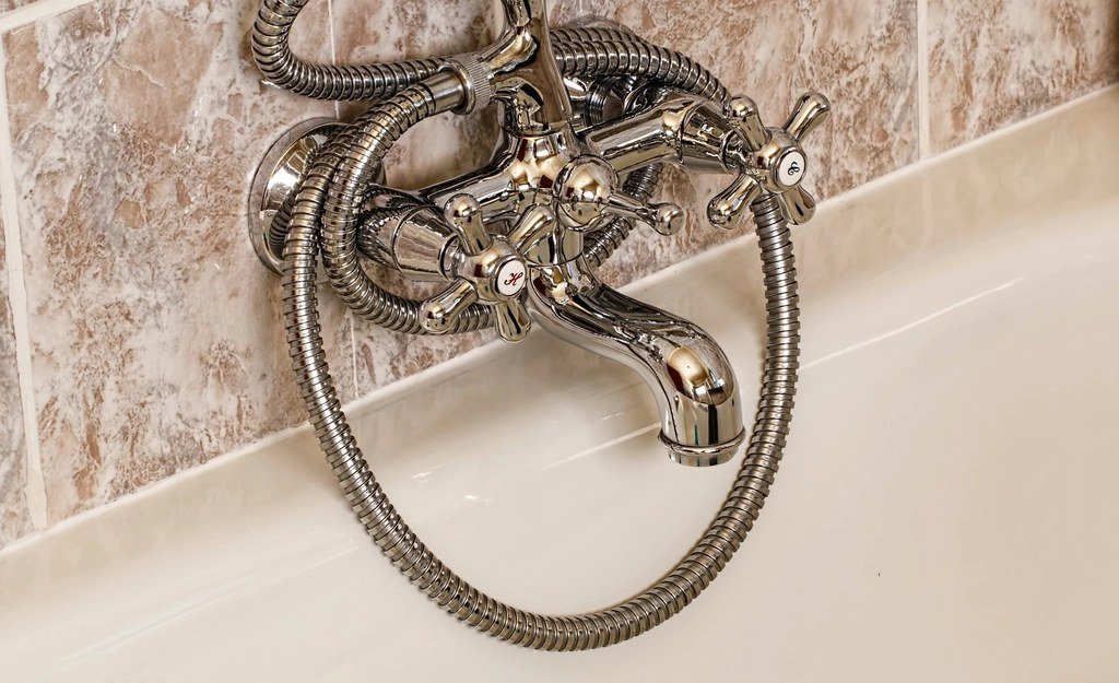 Wall-mounted tub faucet with handheld shower